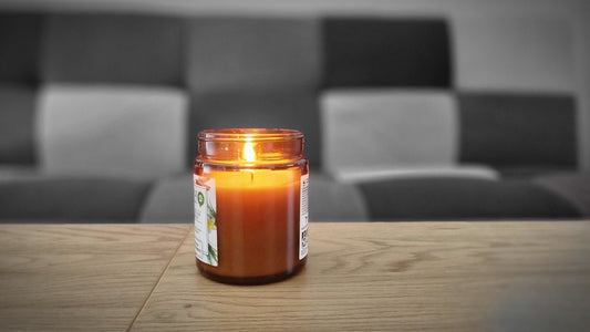 a lit candle sitting on top of a wooden table